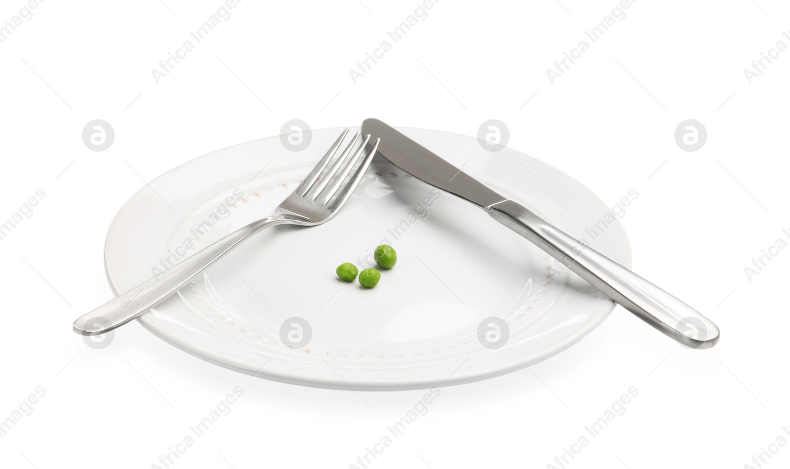 Plate with fresh green peas and cutlery isolated on white Photo of Plate with fresh green peas and cutlery isolated on white