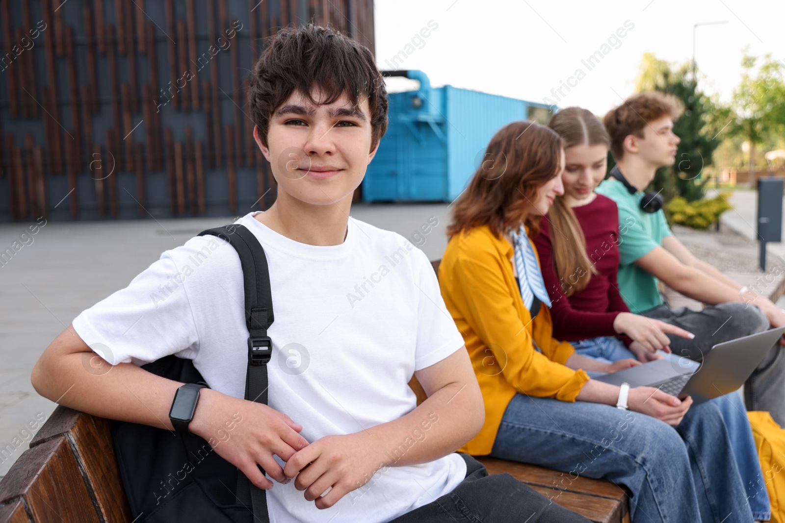 Teenagers spending time together outdoors, selective focus Photo of Teenagers spending time together outdoors, selective focus