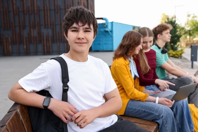 Photo of Teenagers spending time together outdoors, selective focus