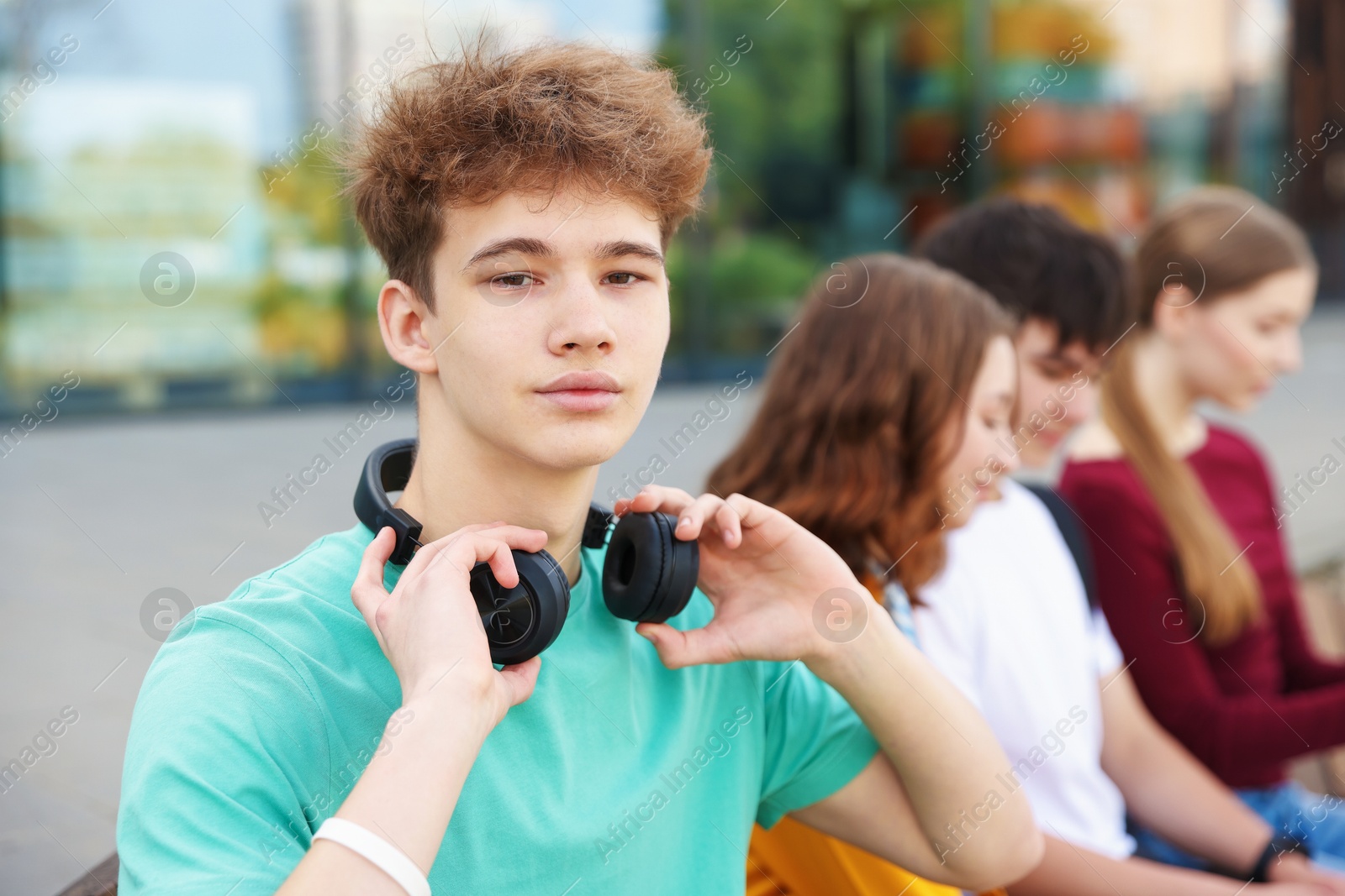 Teenagers spending time together outdoors, selective focus Photo of Teenagers spending time together outdoors, selective focus