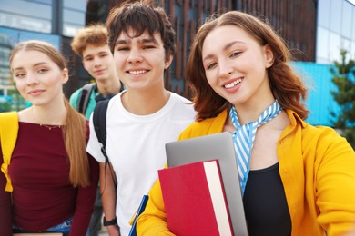 Photo of Group of happy teenagers taking selfie outdoors, selective focus