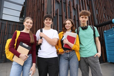 Photo of Group of happy teenagers near building outdoors