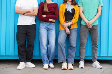 Photo of Group of teenagers near building outdoors, closeup