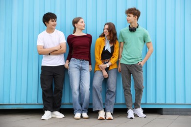 Photo of Group of teenagers posing near building outdoors