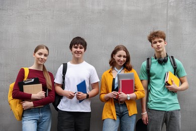 Photo of Group of teenagers posing near building outdoors