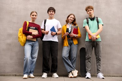 Photo of Group of teenagers posing near building outdoors
