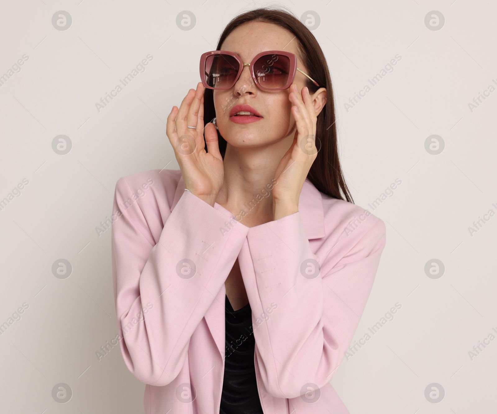 Portrait of beautiful woman in stylish outfit on white background Photo of Portrait of beautiful woman in stylish outfit on white background