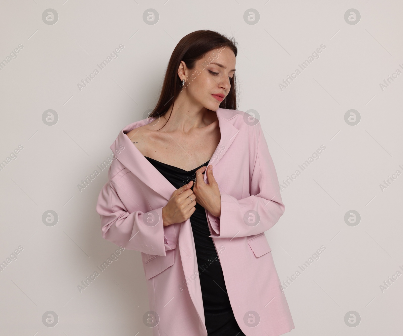 Portrait of beautiful woman in stylish outfit on white background Photo of Portrait of beautiful woman in stylish outfit on white background