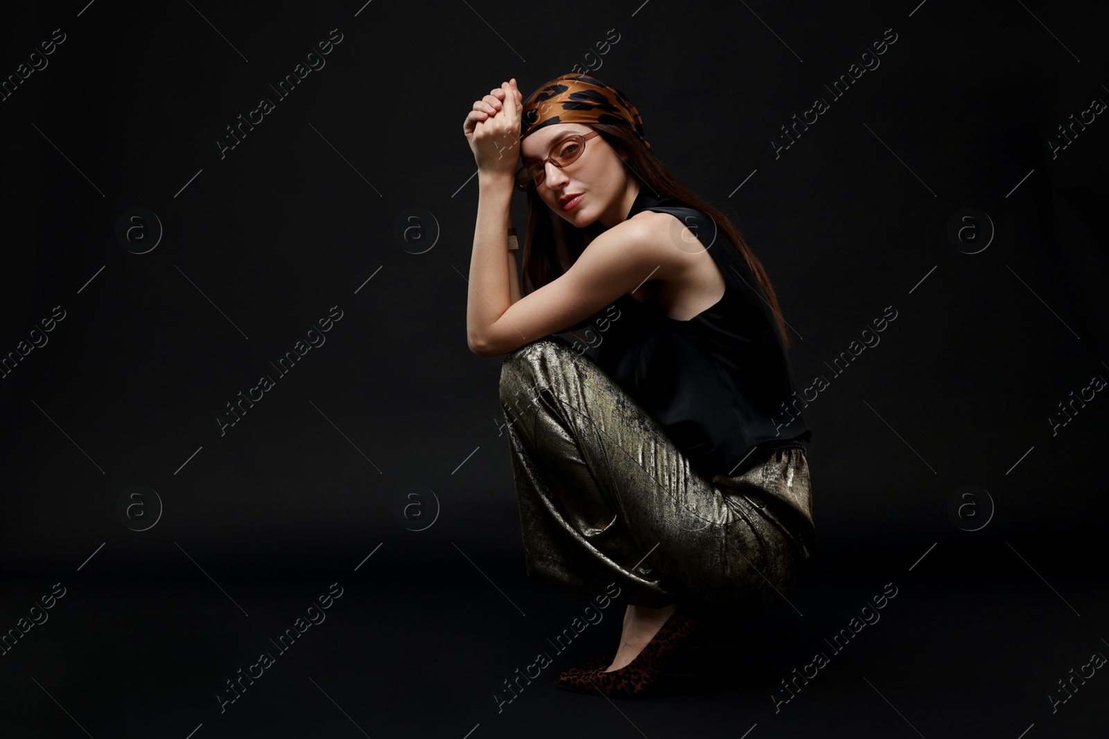 Full-length portrait of beautiful woman in stylish outfit on black background Photo of Full-length portrait of beautiful woman in stylish outfit on black background