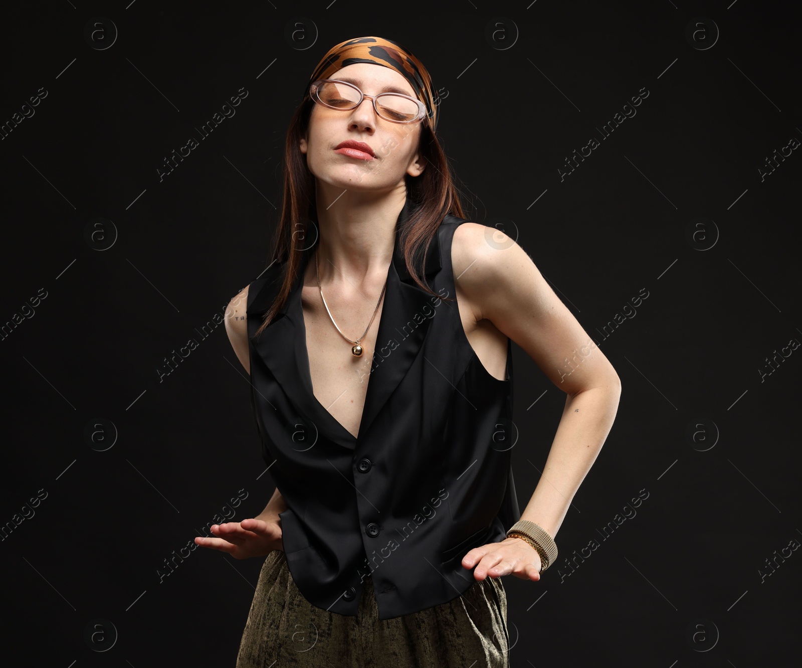 Portrait of beautiful woman in stylish outfit on black background Photo of Portrait of beautiful woman in stylish outfit on black background