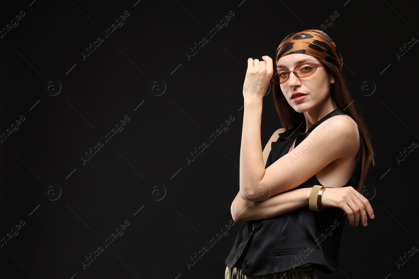 Portrait of beautiful woman in stylish outfit on black background, space for text Photo of Portrait of beautiful woman in stylish outfit on black background, space for text
