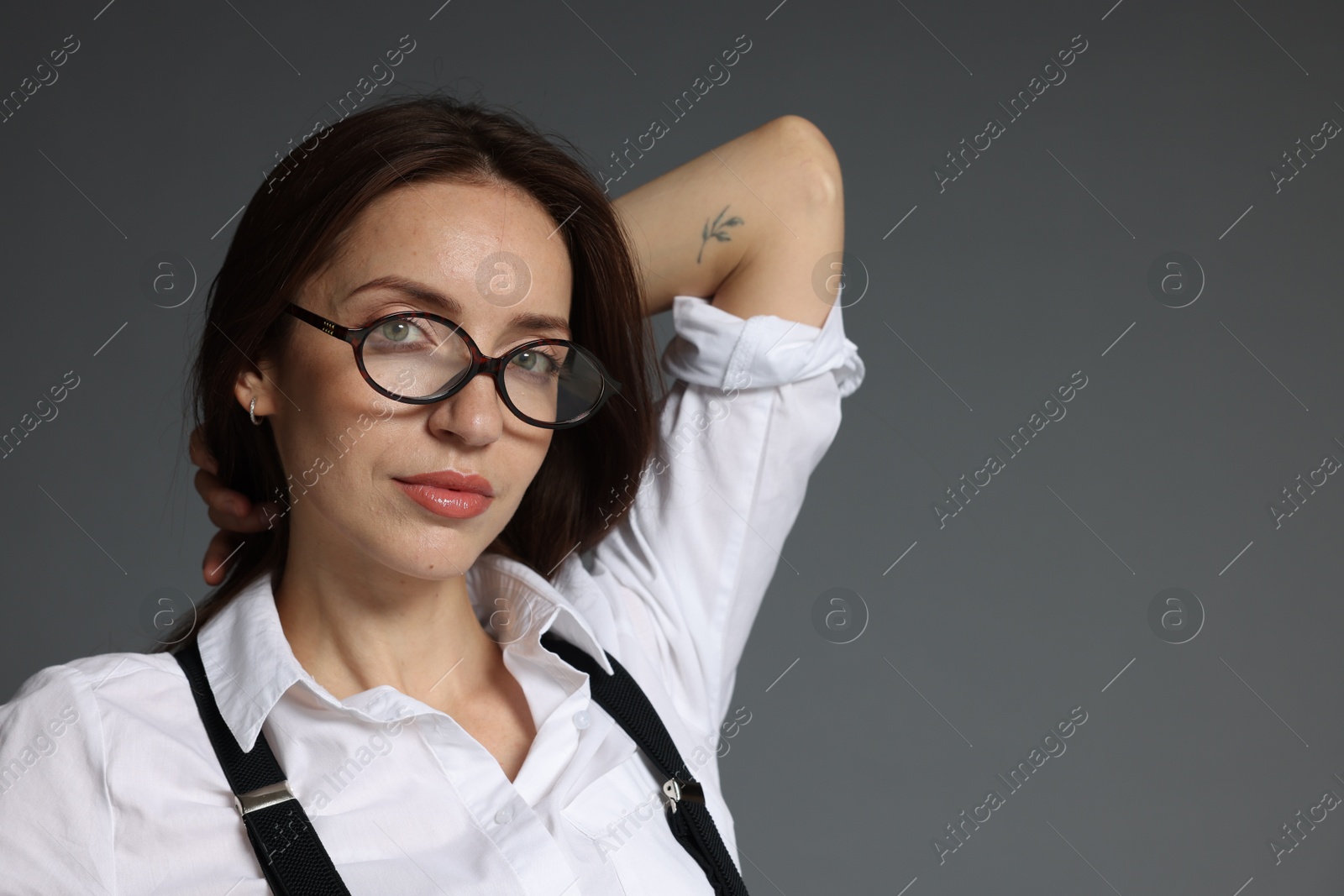 Portrait of beautiful woman in stylish outfit on grey background, space for text Photo of Portrait of beautiful woman in stylish outfit on grey background, space for text