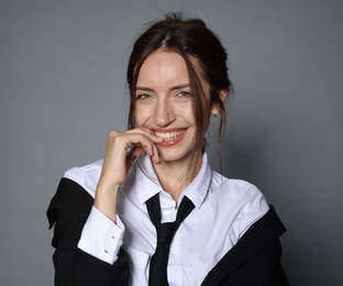 Photo of Portrait of beautiful woman in stylish outfit on light grey background