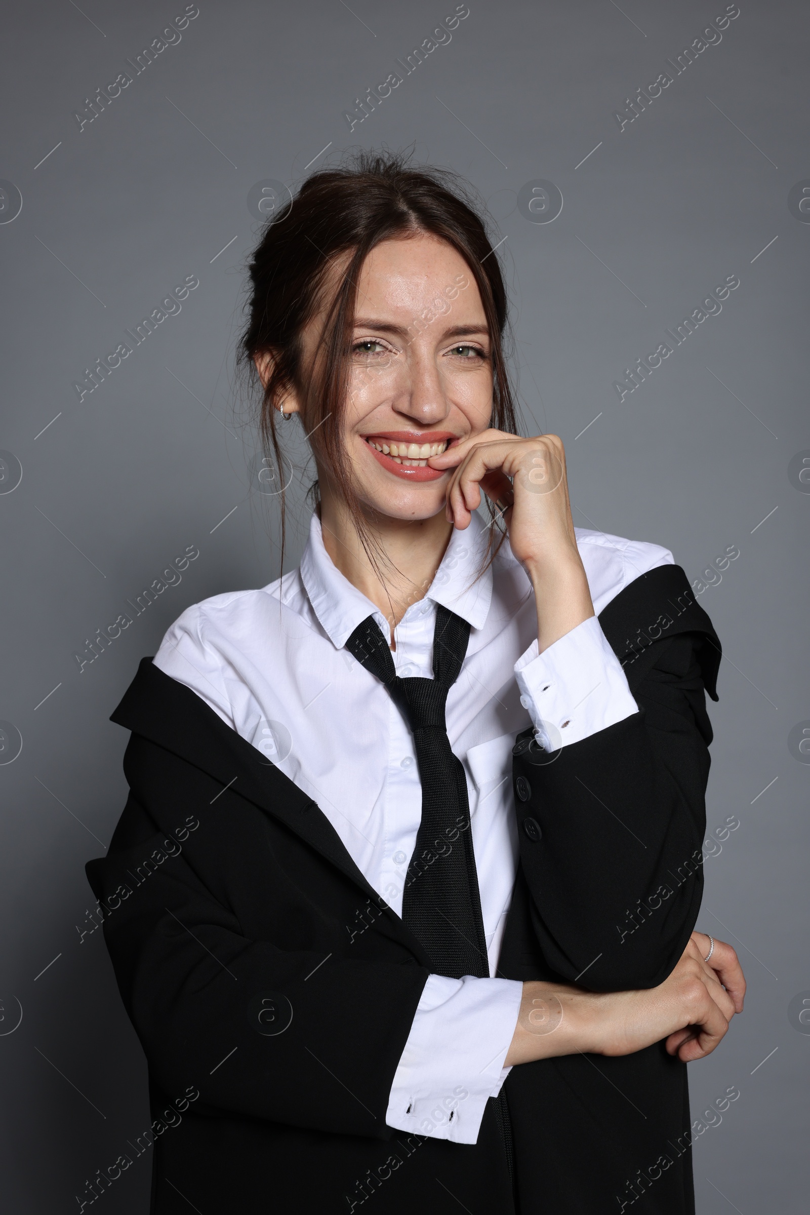 Portrait of beautiful woman in stylish outfit on light grey background Photo of Portrait of beautiful woman in stylish outfit on light grey background