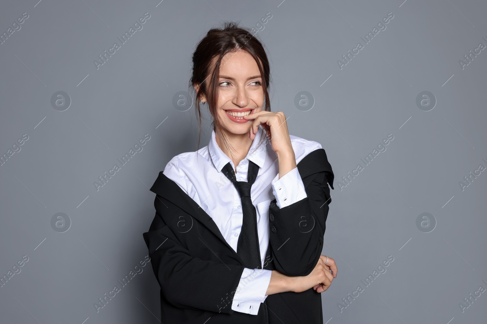 Portrait of beautiful woman in stylish outfit on light grey background Photo of Portrait of beautiful woman in stylish outfit on light grey background