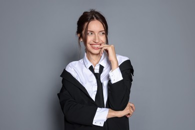 Photo of Portrait of beautiful woman in stylish outfit on light grey background