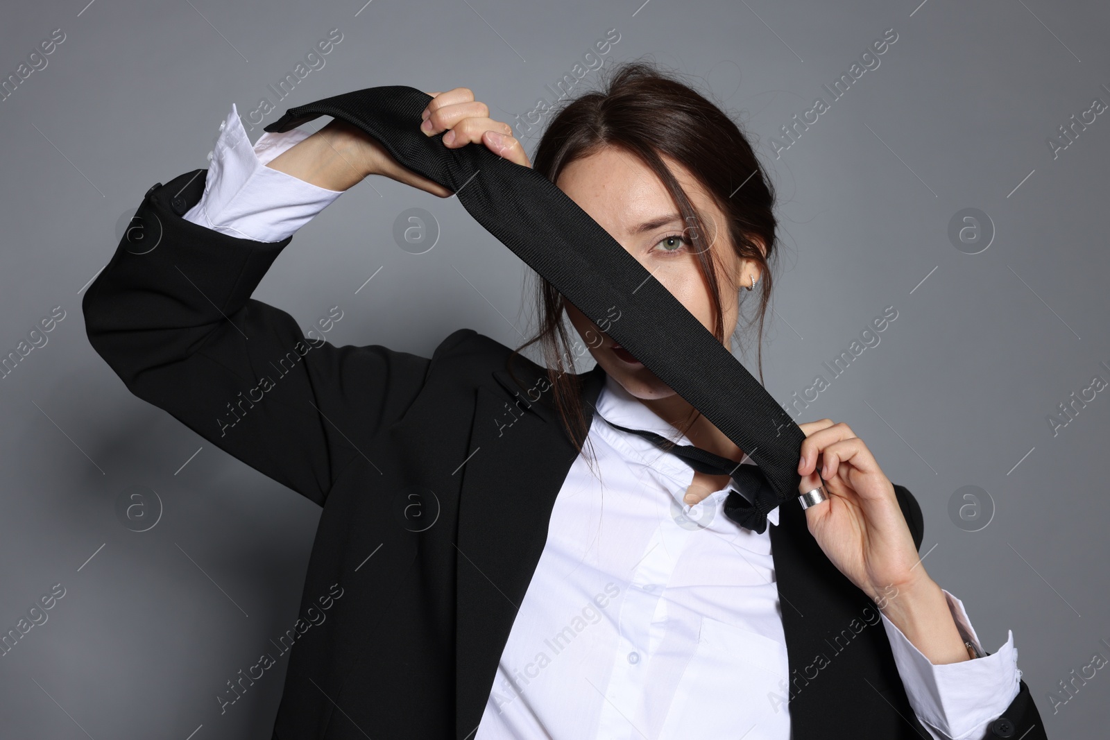 Portrait of beautiful woman in stylish outfit on light grey background Photo of Portrait of beautiful woman in stylish outfit on light grey background