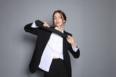 Photo of Portrait of beautiful woman in stylish outfit on light grey background
