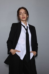 Photo of Portrait of beautiful woman in stylish outfit on light grey background