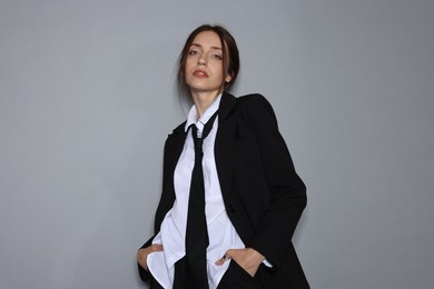 Photo of Portrait of beautiful woman in stylish outfit on light grey background