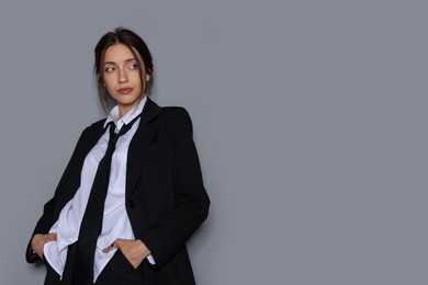 Photo of Portrait of beautiful woman in stylish outfit on light grey background, space for text