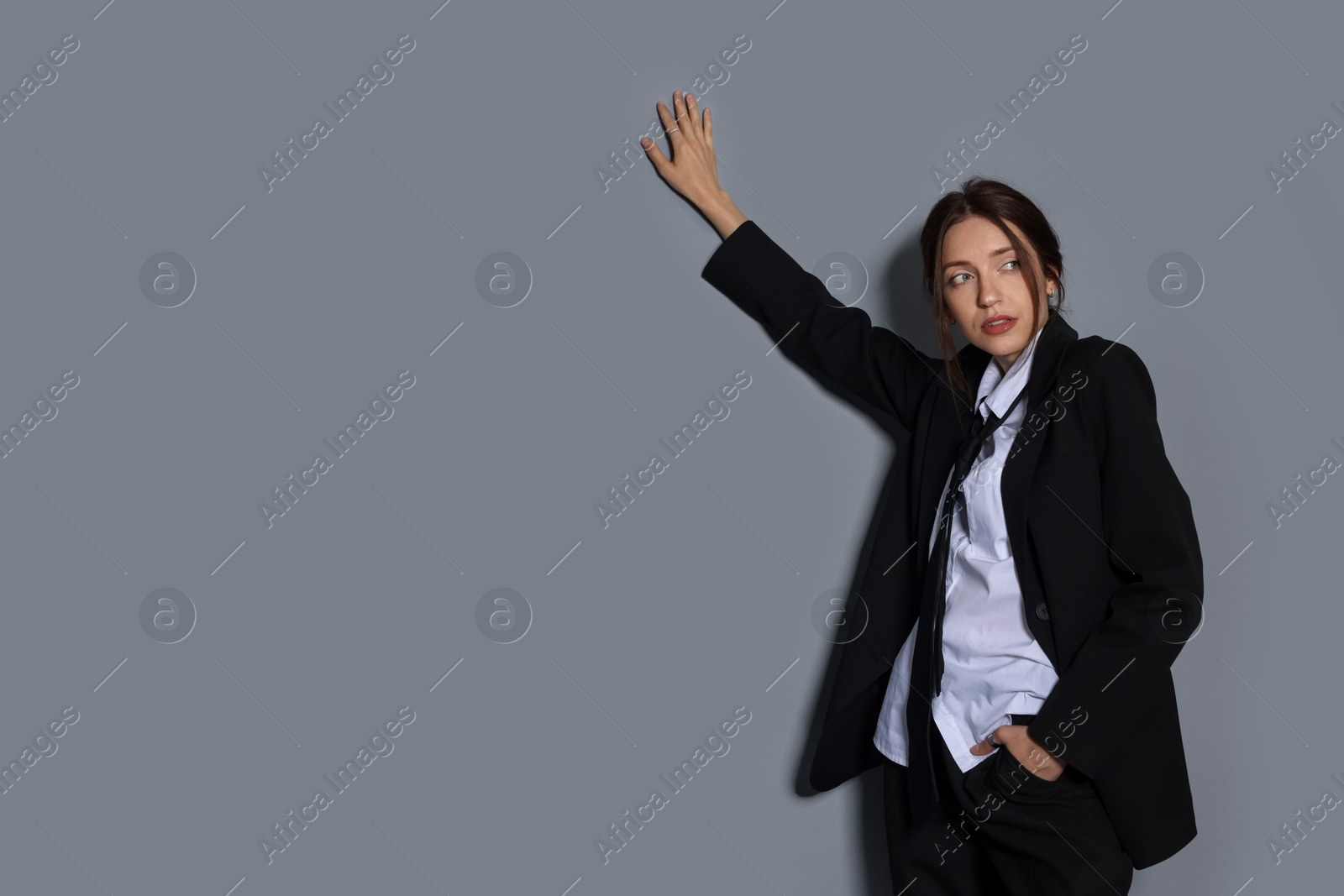 Portrait of beautiful woman in stylish outfit on light grey background, space for text Photo of Portrait of beautiful woman in stylish outfit on light grey background, space for text
