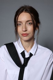 Photo of Portrait of beautiful woman in stylish outfit on light grey background