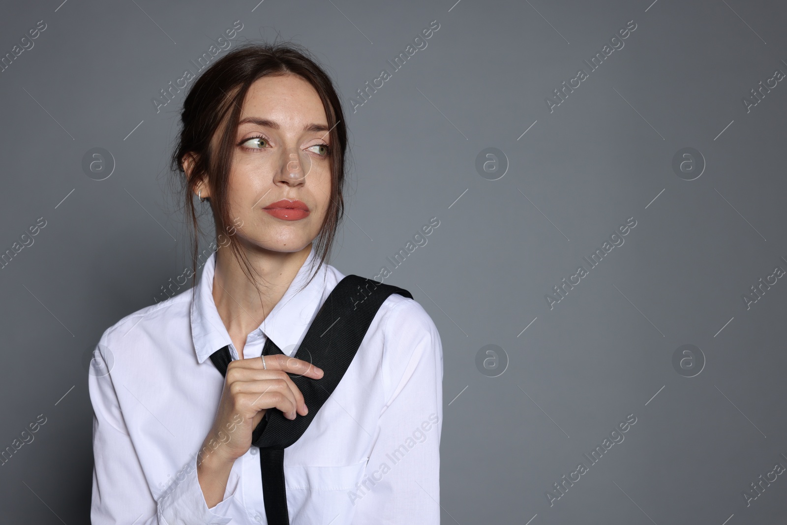 Portrait of beautiful woman in stylish outfit on light grey background, space for text Photo of Portrait of beautiful woman in stylish outfit on light grey background, space for text