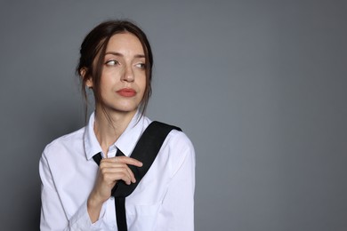 Photo of Portrait of beautiful woman in stylish outfit on light grey background, space for text