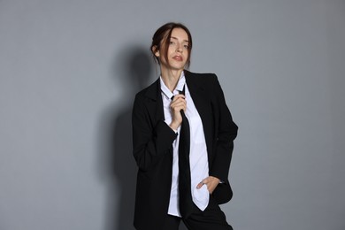 Photo of Portrait of beautiful woman in stylish outfit on light grey background