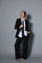 Photo of Full-length portrait of beautiful woman in stylish outfit on light grey background
