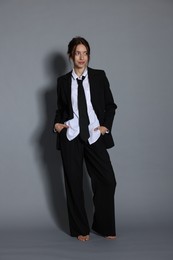 Photo of Full-length portrait of beautiful woman in stylish outfit on light grey background