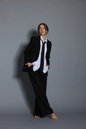 Photo of Full-length portrait of beautiful woman in stylish outfit on light grey background