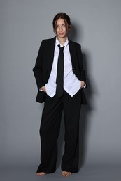 Photo of Full-length portrait of beautiful woman in stylish outfit on light grey background