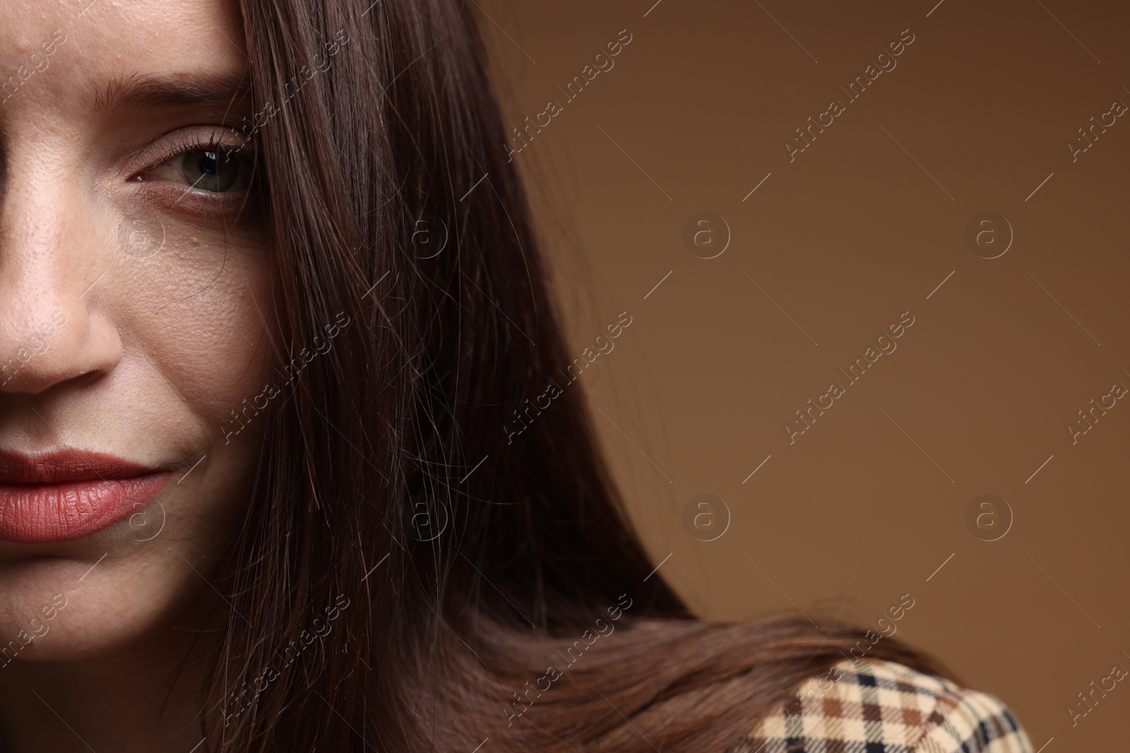 Beautiful woman in stylish outfit on brown background, closeup. Space for text Photo of Beautiful woman in stylish outfit on brown background, closeup. Space for text