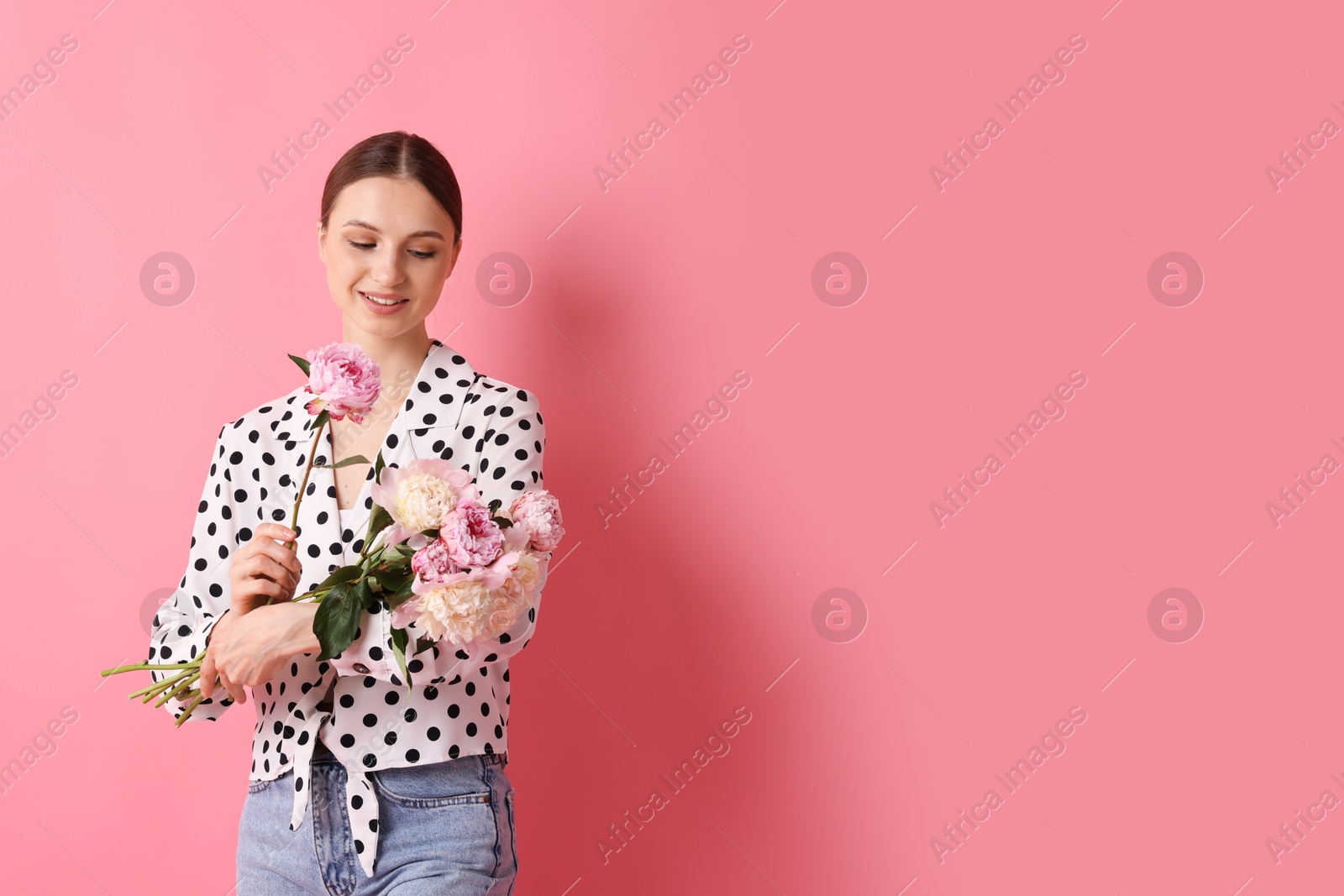 Woman with beautiful bouquet of peonies on pink background, space for text Photo of Woman with beautiful bouquet of peonies on pink background, space for text