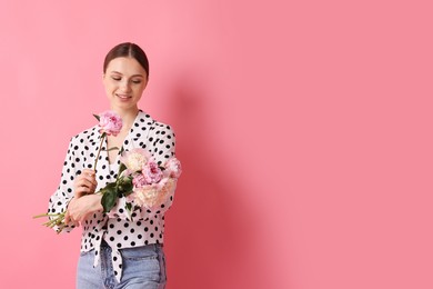 Photo of Woman with beautiful bouquet of peonies on pink background, space for text