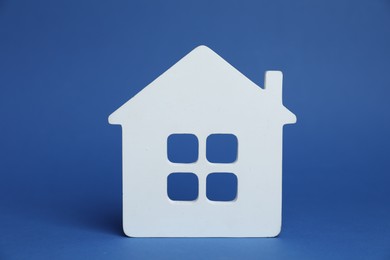 Photo of One white house model on blue background
