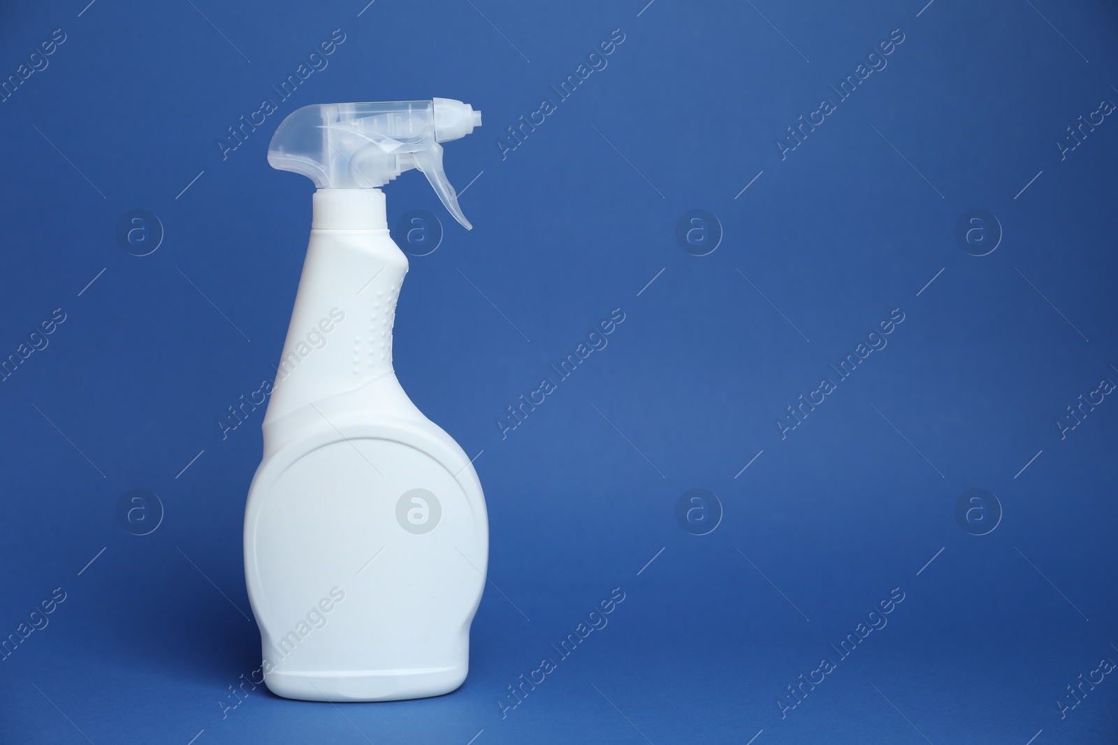 White spray bottle of cleaning product on blue background, space for text Photo of White spray bottle of cleaning product on blue background, space for text