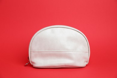 Photo of One white cosmetic bag on red background