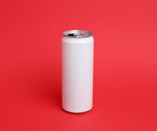 Photo of One white tin can on red background