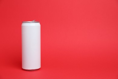 Photo of One white tin can on red background, space for text