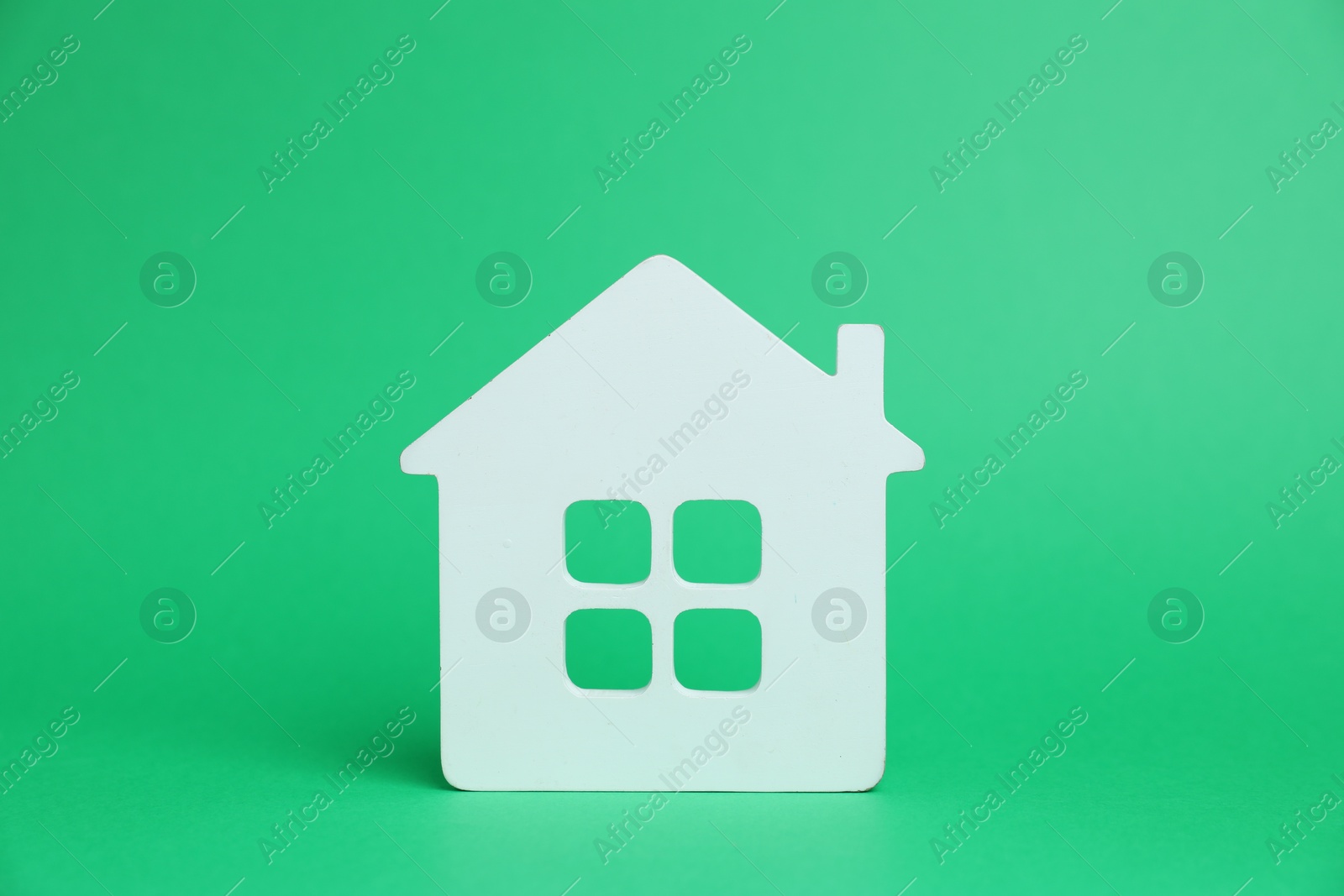 One white house model on green background Photo of One white house model on green background