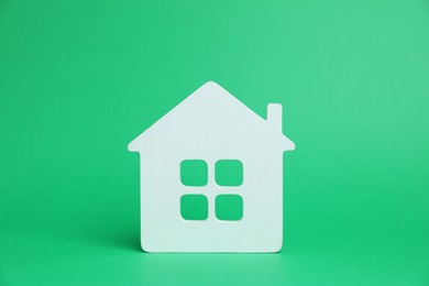 Photo of One white house model on green background