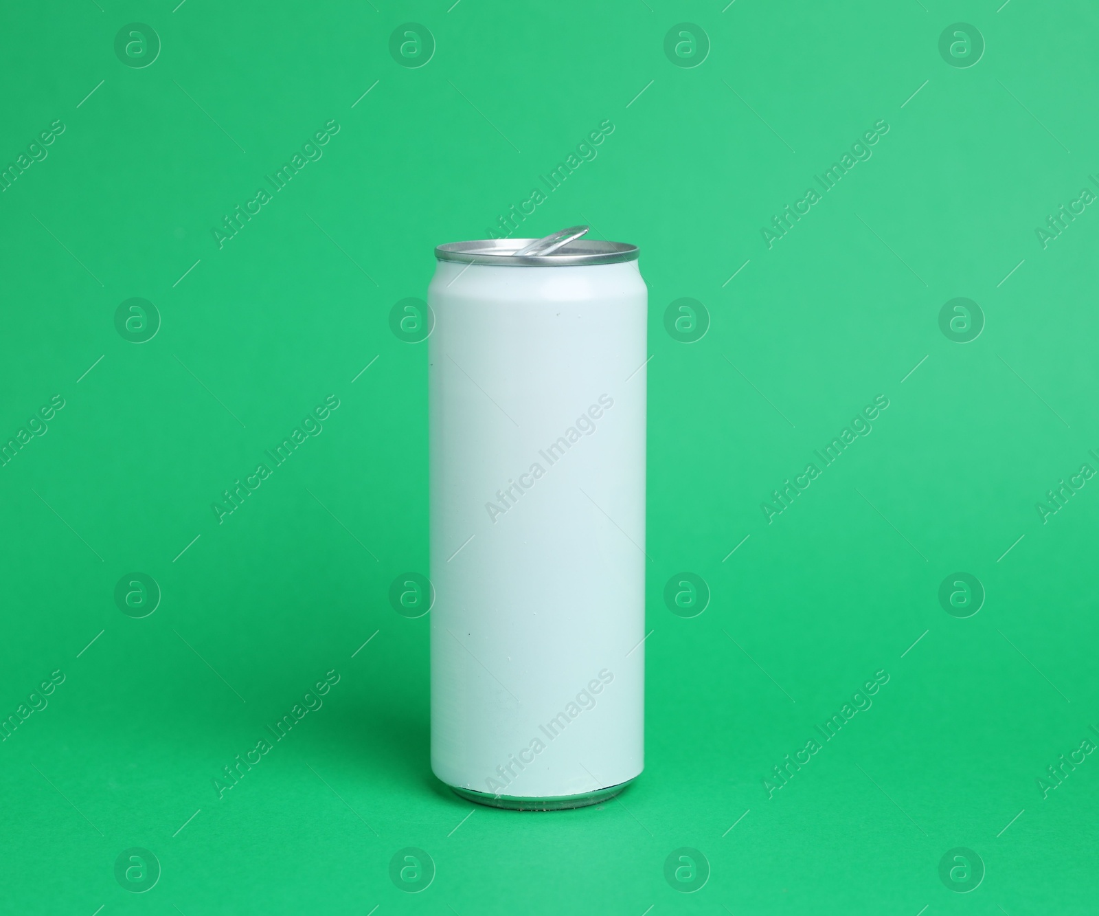 One white tin can on green background Photo of One white tin can on green background