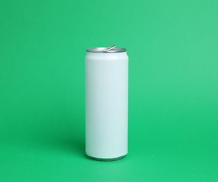 Photo of One white tin can on green background