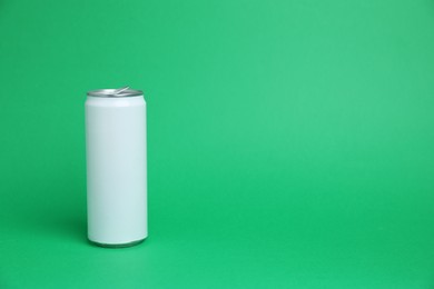 Photo of One white tin can on green background, space for text