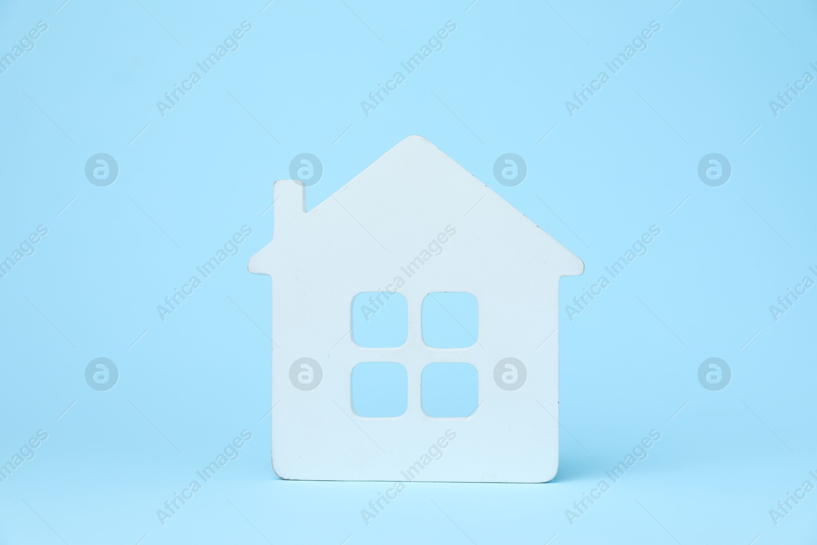 One white house model on light blue background Photo of One white house model on light blue background