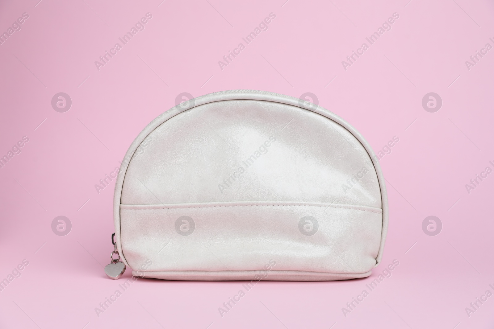 One white cosmetic bag on pink background Photo of One white cosmetic bag on pink background