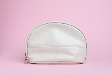 Photo of One white cosmetic bag on pink background